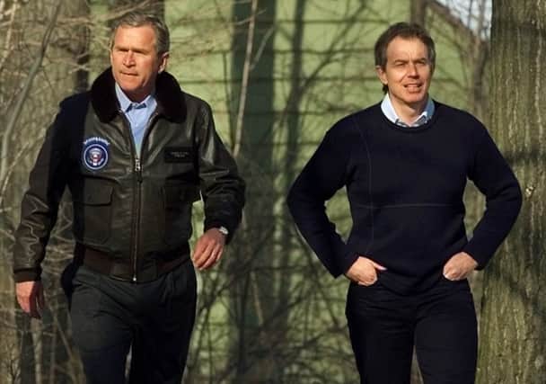 President Bush walks with British Prime Minister Tony Blair and Bush's dog Spot, following their lunch at  Camp David in 2001.  (AP Photo/Doug Mills)