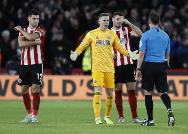 Dean Henderson of Sheffield Utd asks the referee how VAR can rule the goal when they had stopped playing for a linesman's flag. Picture: Simon Bellis/Sportimage