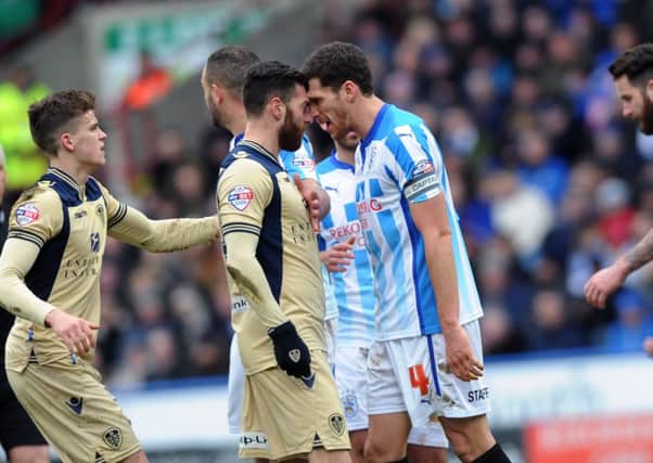 Leeds United's Mirco Antenucci and Huddersfield's Mark Hudson clash during the January 2015 encounter at the John Smith's Stadium.
 Picture: Jonathan Gawthorpe.