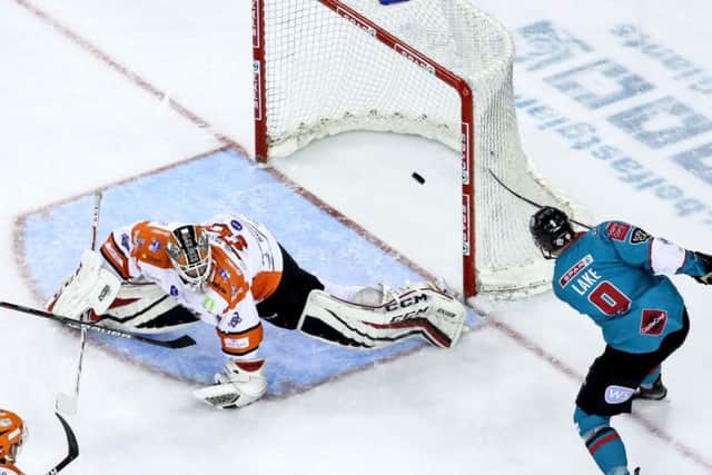 Ben Lake sweeps the puck past Tomas Duba in the Steelers' goal to make it 5-0. Picture courtesy of Press Eye/EIHL.