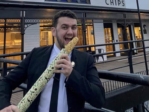 Manager Bailey Thornton at the Cleethorpes branch of the family-owned Yorkshire chippy Papas, holding the 'world's largest pig in blanket'. Credit: SWNS