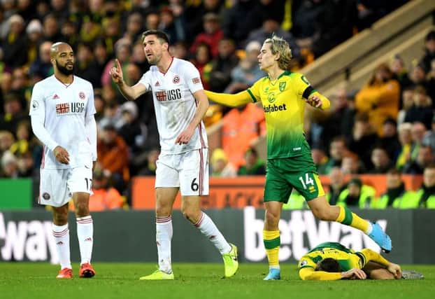 Sheffield United's Chris Basham reacts after fouling Norwich City's Kenny McLean. He received a red card, which was then rescinded by VAR (Picture: Joe Giddens/PA Wire).
