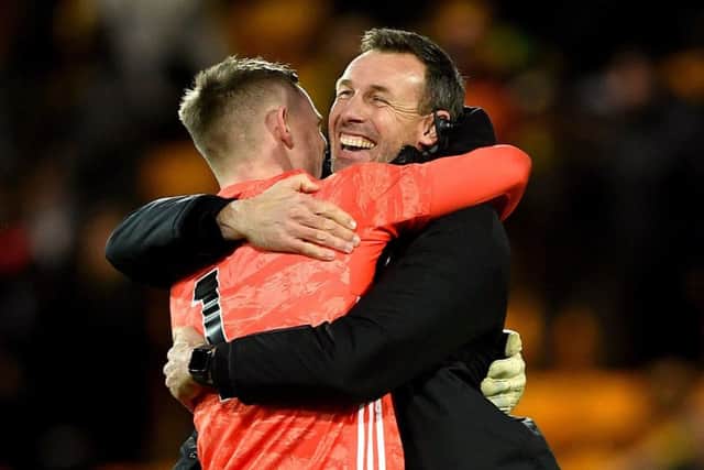 Sheffield United's goalkeeper Dean Henderson embraces goalkeeping coach Darren Ward after the final whistle at Carrow Road on Sunday (Picture: Joe Giddens/PA Wire).