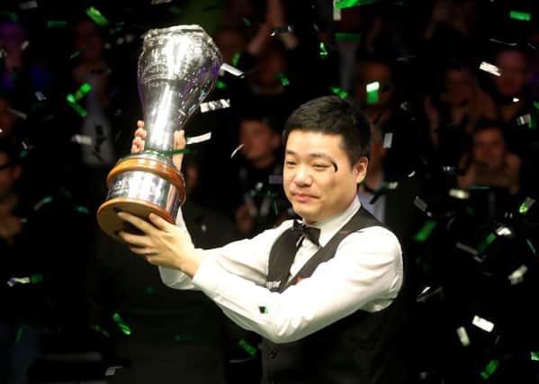 Ding Junhui celebrates with the trophy in York.