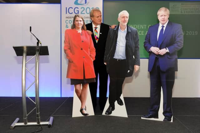 care campaigner Mike Padgham with cardboard cutouts of Jo Swinson, Boris Johnson and Jeremy Corbyn to illustrate their non-attendance at a major conference in York on the issue of social care.