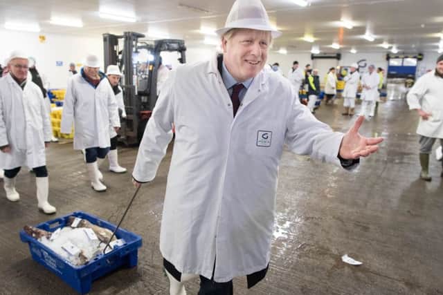 Prime Minister Boris Johnson during a visit to Grimsby Fish Market, while on the General Election campaign trail.