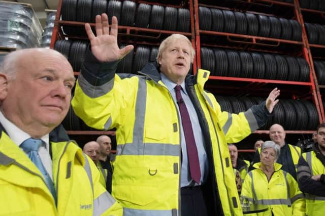 Prime Minister Boris Johnson gestures as he takes questions during a visit to Fergusons Transport in Washington, Tyne & Wear, while on the general election campaign trail.