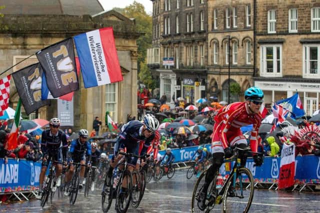 The Elite Men Road Race peloton passes the Royal Pump Rooms to climb Cornwall Road in Harrogate during in the UCI World Championships 2019.
