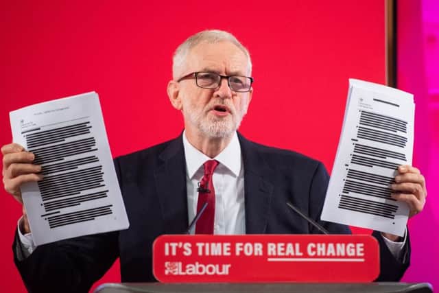 Labour leader Jeremy Corbyn holds redacted copies of the Department for International Trade's UK-US Trade and Investment Working Group report following a speech about the NHS, in Westminster.