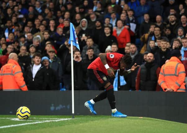 Victim: Manchester United's Fred reacts after objects are thrown at him during the Premier League match at the Etihad Stadium.