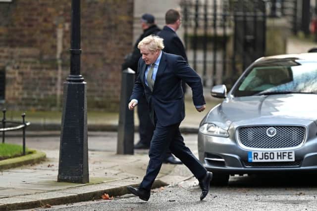 Boris Johnson strides up 10 Downing Street after his audience with the Queen.
