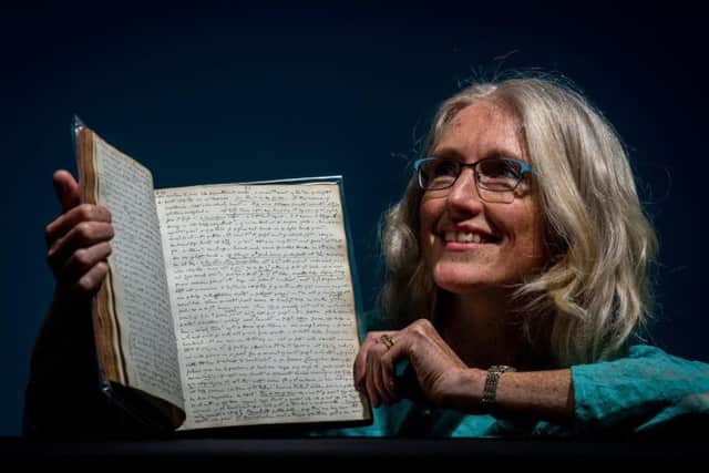 Shirley Jones, Head of Conservation at West Yorkshire Archive Service with a volume of Anne's diary.