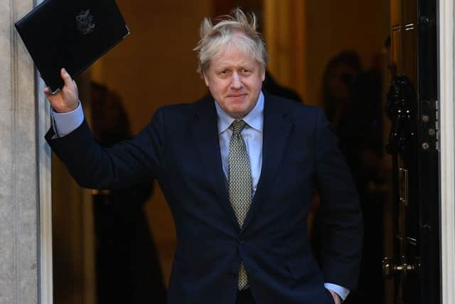 Boris Johnson waves on the steps of 10 Downing Street after his election win. Photo: Victoria Jones/PA Wire