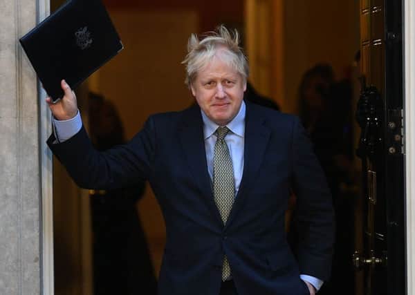 Boris Johnson waves on the doorstep of Downing Street after his election win.