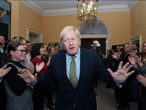 Prime Minister Boris Johnson is greeted by staff as he arrives back at 10 Downing Street, London. Photo: Stefan Rousseau/PA Wire