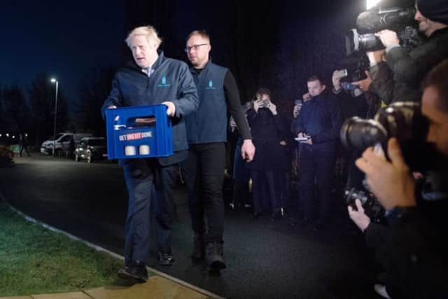 Prime Minister Boris Johnson delivers milk in Guiseley, Leeds, ahead of Thursday's General Election. Picture: Stefan Rousseau/PA Wire
