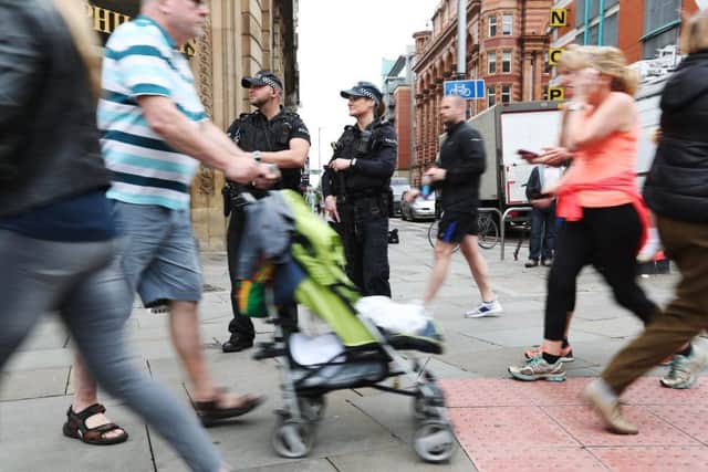 Armed police officers on patrol as thousands of defiant runners and spectators turn out for the Great Manchester Run, following the terror attack at the Manchester Arena in the city in 2017. Picture: Jonathan Brady/PA Wire