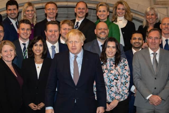 Boris Johnson is pictured with newly-elected Tory MPs.