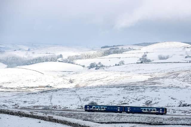A train on the Settle to Carlisle line passes through Ribblehead