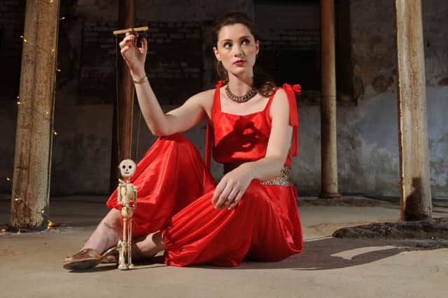 Rose Muirhead wears 1970s red disco jumpsuit from Vintage Beau, 1980s necklace, from Rose & Brown Vintage; with skeleton Pelham Puppet from Owen Collectables. At Sunnybank Mills in Farsley, Leeds. Picture by Tony Johnson.
