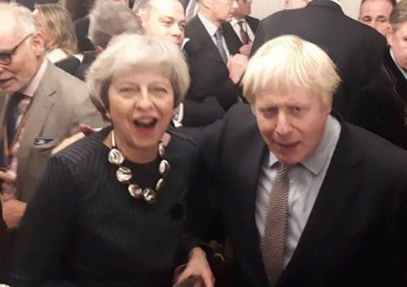 Boris Johnson savours his election win with his predecessor Theresa May.