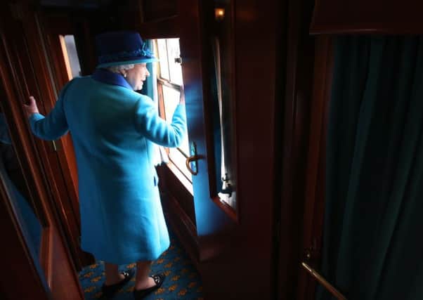 Queen Elizabeth II on the day she became Britain's longest reigning monarch, travelling on a steam train to inaugurate the new  Scottish Borders Railway.