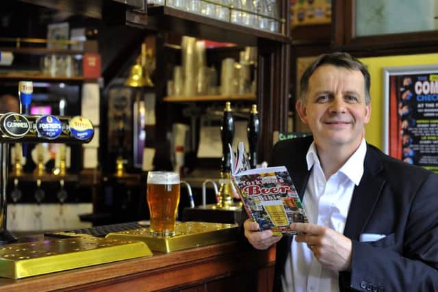 Simon Jenkins checking out a pint  at The Fenton on Woodhouse Lane in Leeds , with his new book The Yorkishire Beer Bible.
