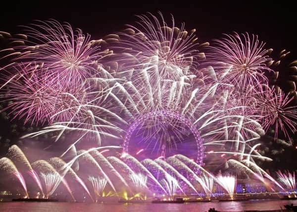 Fireworks light up the sky over the London Eye during the New Year celebrations.  Photo: Yui Mok/PA Wire