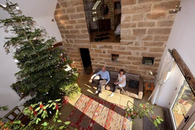 Danny Nightingale and his wife Liz in one of their barn conversions. Credit: Richard Ponter