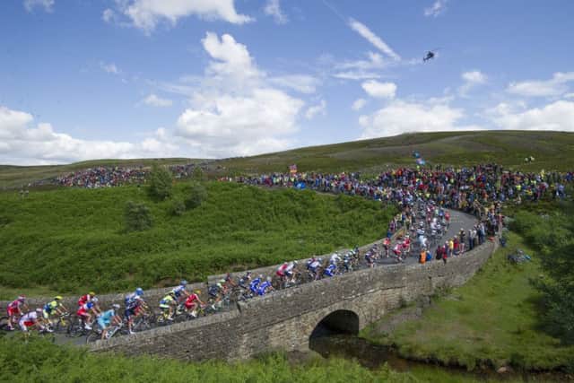 The peloton rides over a bridge on the Grinton Moor, Yorkshire during the 2014 Tour de France. Picture:Tim Goode/PA Wire