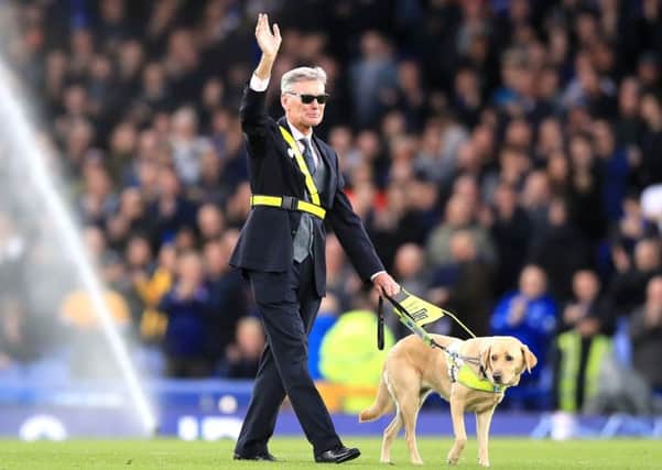 Former Everton player Dave Thomas with his guide dog Hannah during half-time at Goodison Park earlier this season. Picture: Peter Byrne/PA