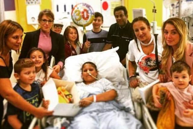 Rebecca Ali, pictured in hospital surrounded by family, received a transplant just before her 30th birthday. Image: Family own