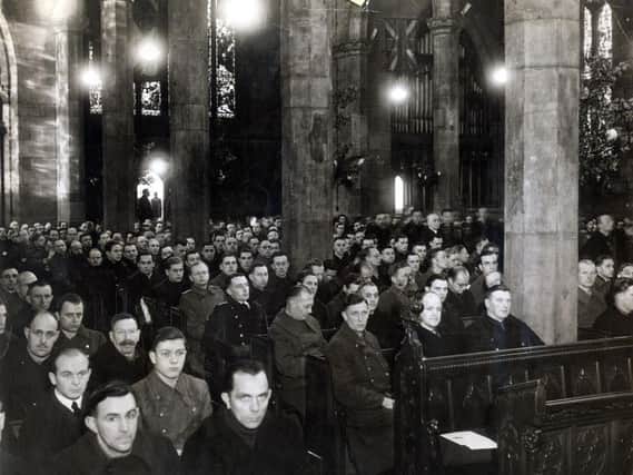 German prisoners of war listening to the Bishop of Berlin at a Christmas eve service in Sheffield Cathedral, 1946. Over 1000 POWs attended.