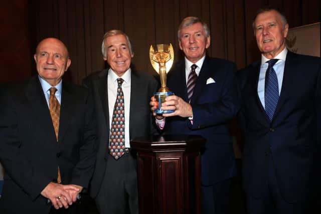 OLD FRIENDS: Martin Peters, second right, pictured with Sir Geoff Hurst, right, and George Cohen, left and Gordon Banks with the Jules Rimet trophy in January 2016 at the Royal Garden Hotel. Picture: Adam Davy/PA.