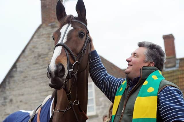 Record-breaking King George trainer Pauil Nicholls celebrates the legendary Kauto Star's fifth win in the big race in 2011.