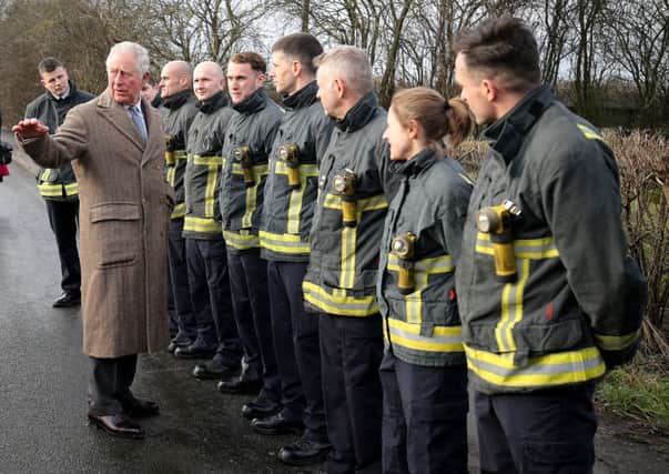 The Prince of Wales meets emergency service personnel during a visit to Fishlake, in South Yorkshire, which was hit by floods earlier this year.  Picture: Nigel Roddis/PA Wire