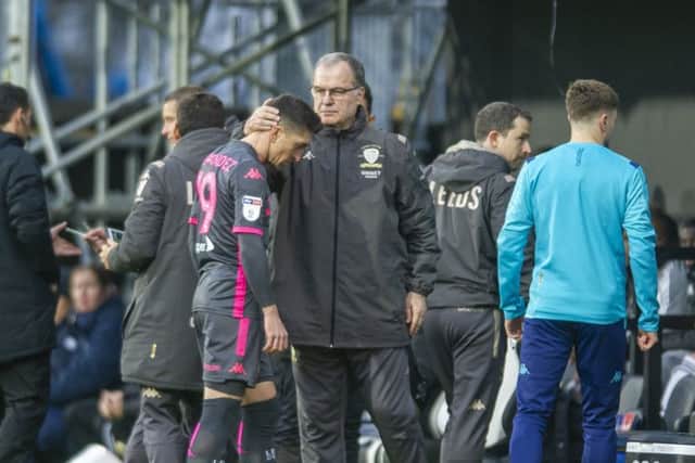 INJURY BLOW: Pablo Hernandez is consoled on the touchline by Marcelo Bielsa after pulling up injured in the opening minutes at Craven Cottage on Saturday. Picture: Tony Johnson