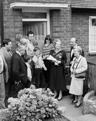 Margaret Thatcher hands over a copy of the deeds of 39 Amersham Road, Harold Hill, in Essex, to James Patterson, the GLC's 12,000 council house buyer.