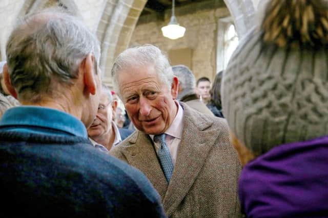 The Prince of Wales speaks to local residents during a visit to Fishlake, in South Yorkshire, which was hit by floods earlier this year.