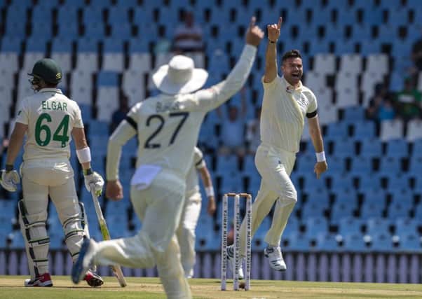 England's bowler James Anderson, right, celebrates with teammates after dismissing South Africa's Dean Elgar, far left, for a duck on day one of the first cricket test match between South Africa and England at Centurion Park, Pretoria. (AP Photo/Themba Hadebe)