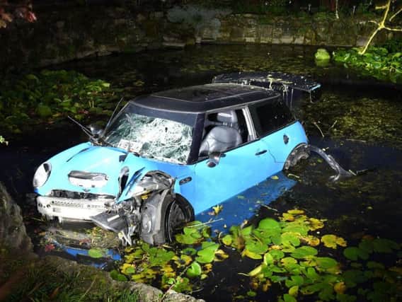 Kitching's Mini Cooper ended up in a pond after he crashed his car during the high speed chase. Credit: NYP