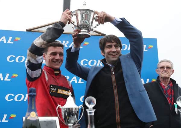 Jockey Jack Tudor and trainer Christian Williams celebrate the Welsh National win of Potters Legend.