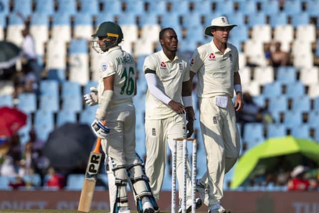 England's Jofra Archer, center, celebrates with Stuart Broad after dismissing South Africa's batsman Keshav Maharaj on day two at Centurion Park. Picture: AP/Themba Hadebe.