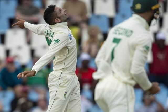 South Africa's bowler Keshav Maharaj, left, celebrates after dismissing England's batsman Dom Sibley for 29 runs on day three. (AP Photo/Themba Hadebe)