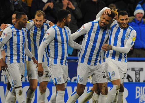 Steve Mounie is mobbed after his goal for Huddersfield helped beat Blackburn. But how many Town players made our Team of the Week? (Picture: Steve Riding)