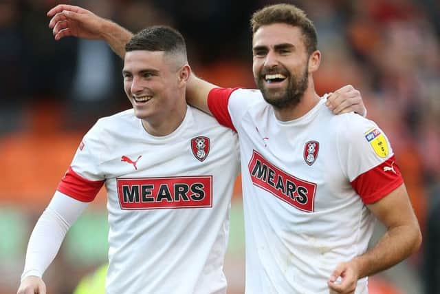 Rotherham United's Clark Robertson, right, celebrating the win over Blackpool in October, will miss the return game on Wednesday. (Picture: PA)