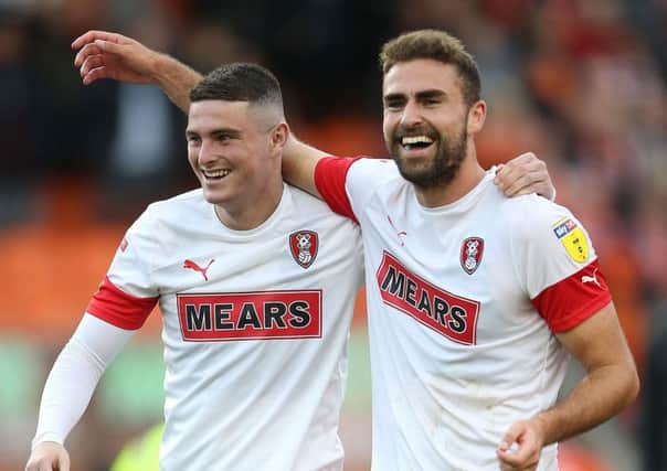 Rotherham United's Clark Robertson, right, celebrating the win over Blackpool in October, will miss the return game on Wednesday. (Picture: PA)