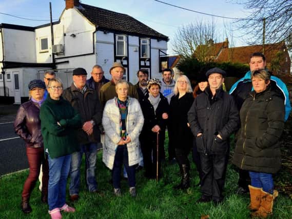 Residents of Holmpton village outside the George and Dragon pub on New year's Eve Picture: Gary Longbottom