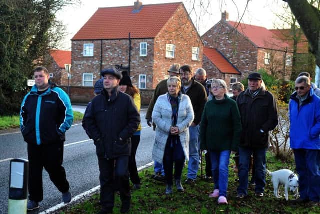 Villagers walking towards the pub in Holmpton on the second anniversary of its closure Picture: Gary Longbottom