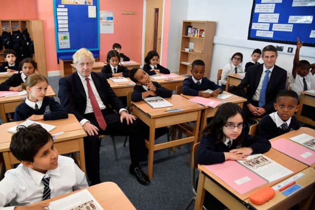 Boris Johnson during a school visit with Education Secretary Gavin Williamson (right).